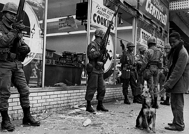 Soldiers stand guard in front of a supermarket on 63rd Street on Chicago's South Side in 1968. (AP)