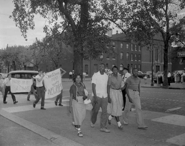1954年巴尔的摩大学，非裔美国人的学生被后面的白人抗议。